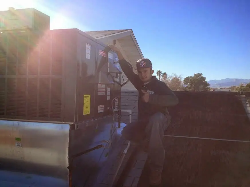 HVAC technician performing AC Tune-Up on a rooftop unit in Catalina Foothills